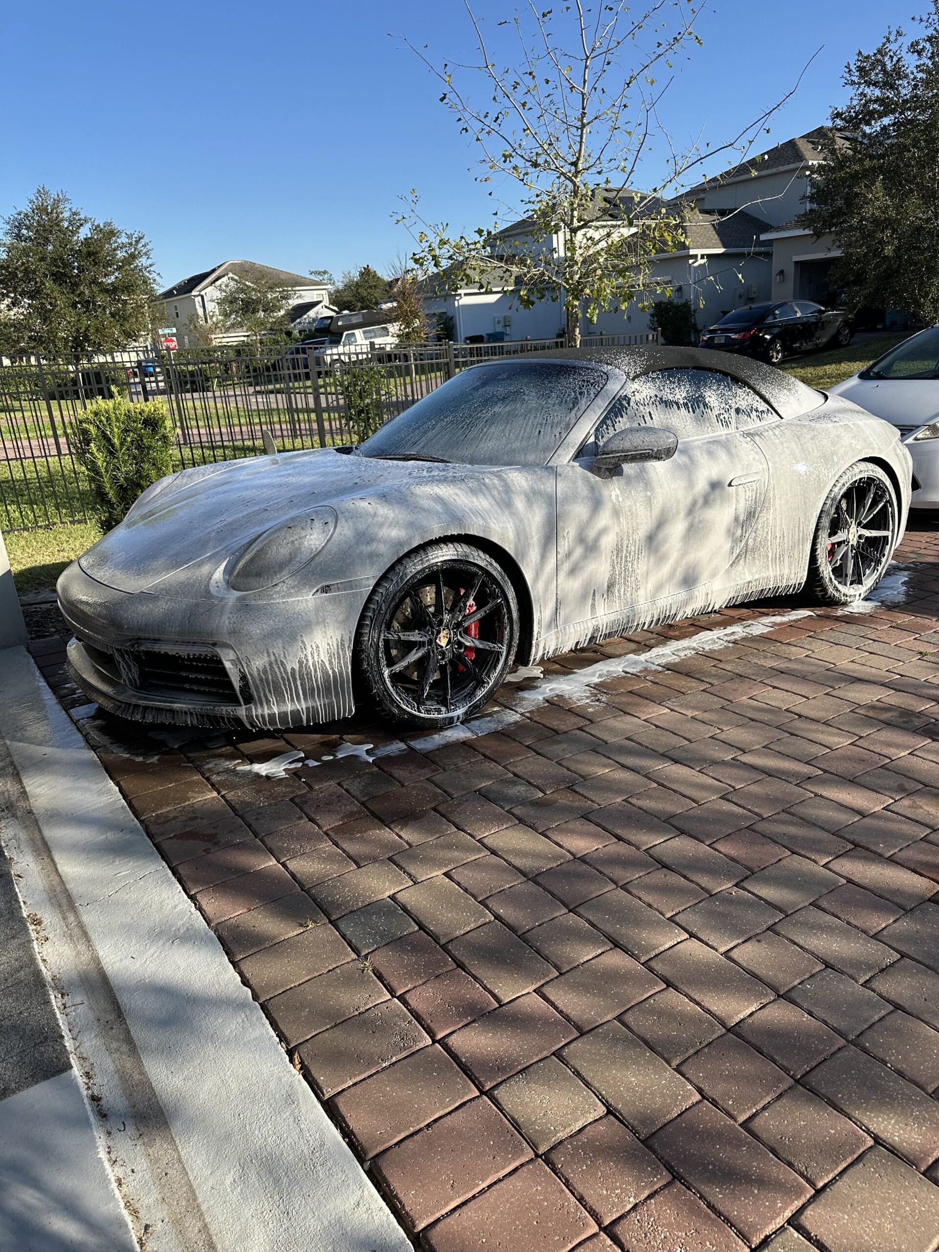 Car covered in foam during mobile detailing service